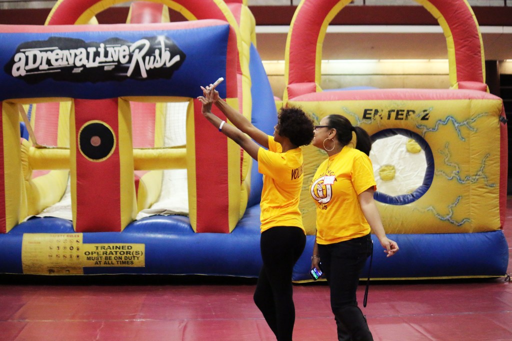 Jackie Taylor (left) and Aja Gore (right), volunteers at the the 2015 Up All Night Event, take a selfie before the line of students is let into the event on Saturday, March 28, 2015. 