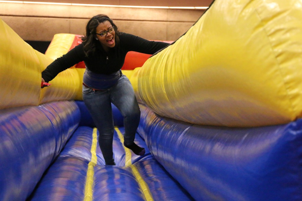 Tatyana Greene runs to place a bean bag further than her opponent while fight an elastic bungee pulling he back at the 2015 CMU Up All Night Event on Saturday, March 28, 2015. 