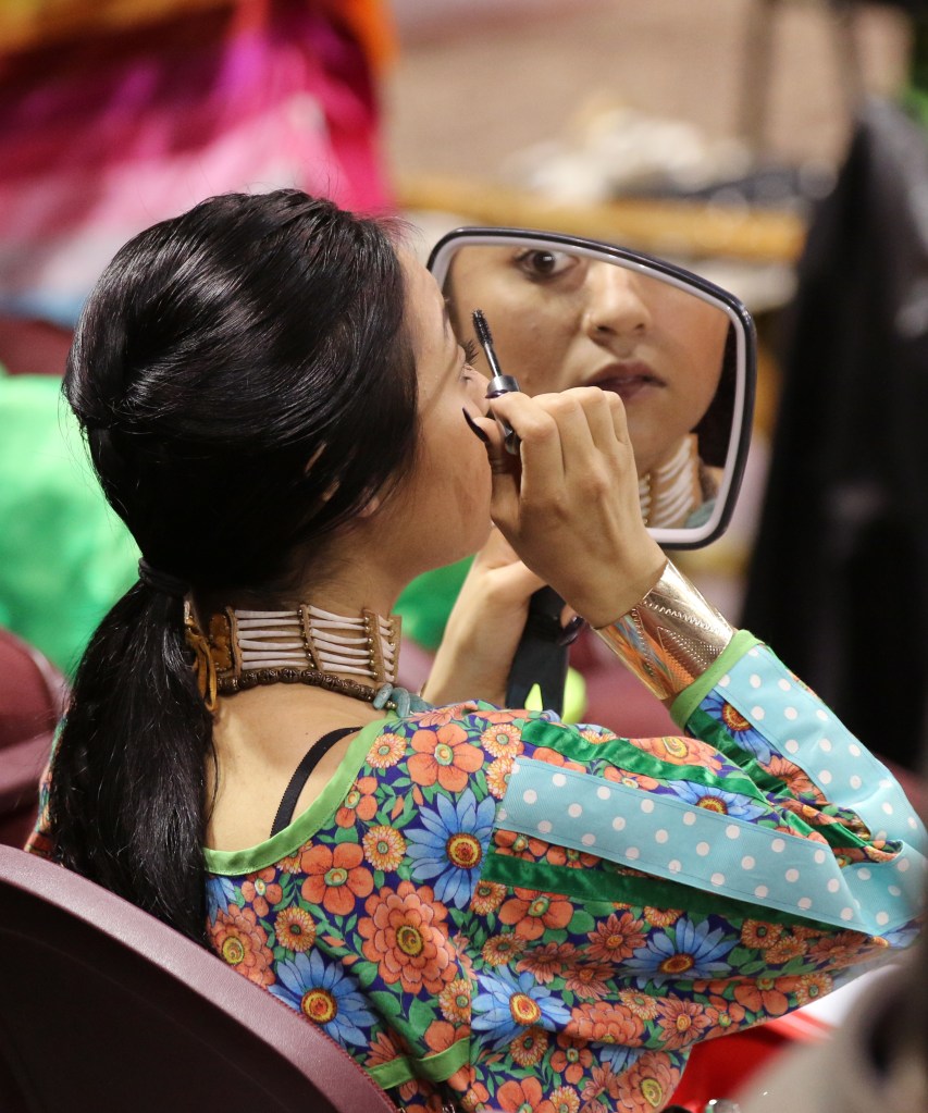 Tess Knight prepares for the dancing competition at the 26th Annual Celebrating Life Pow wow in McGuirk Arena on the Campus of Central Michigan University, Saturday, March 21, 2015. 