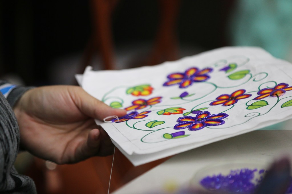 Michelle works on beading a purse at the 26th Annual Celebrating Life Pow wow in McGuirk Arena on the Campus of Central Michigan University, Saturday, March 21, 2015. In addition to dance and drum competitions, there is also an opportunity to buy goods at the Pow wow. 