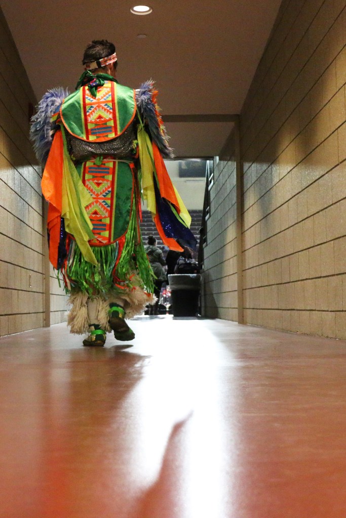 A dancer enters McGuirk Arena before the competition starts at the 26th Annual Celebrating Life Pow wow in McGuirk Arena on the Campus of Central Michigan University, Saturday, March 21, 2015. 