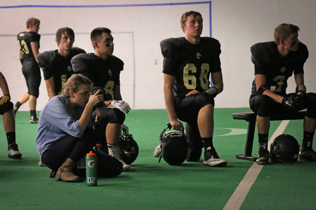 Erin Kirkland of the Midland Daily news takes photos of the Bullock Creek football team in their locker room before the Homecoming game on Friday, Sept. 18, 2015.
