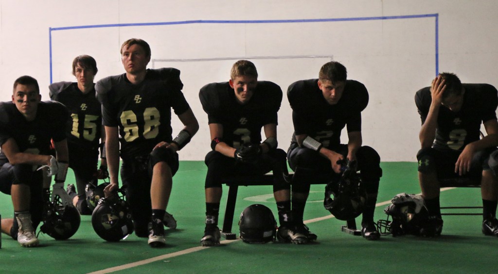 The Bullock Creek Varsity Football team gathers in the locker room before walking out to the field for their Homecoming game on Friday, Sept. 19, 2015. 