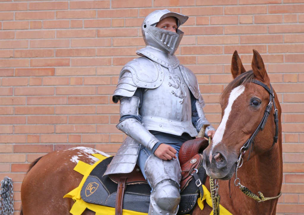 Bullock Creek student and member of the Equestrian team Nathan Wallace waits with Sundae before entering the field to kick of the Bullock Creek Homecoming game on Friday, Sept. 18, 2015. 