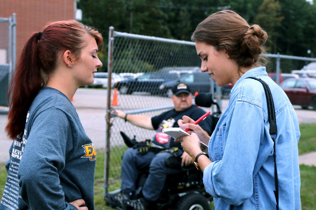 Erin Kirkland of the Midland Daily News interviews a member of the Bullock Creek Equestrian team on Friday, Sept. 18, 2015 at the Bullock Creek Homecoming game. 