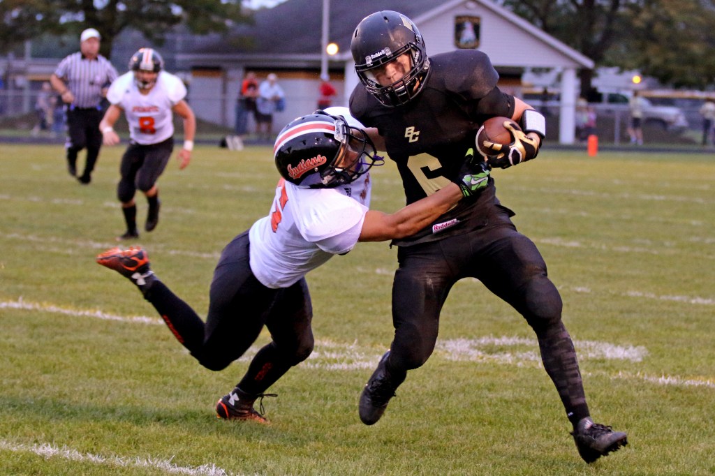 Bullock Creek's Adam McCann (right) resists a tackle at   at the Bullock Creek Homecoming game Friday, Sept. 18, 2015. 