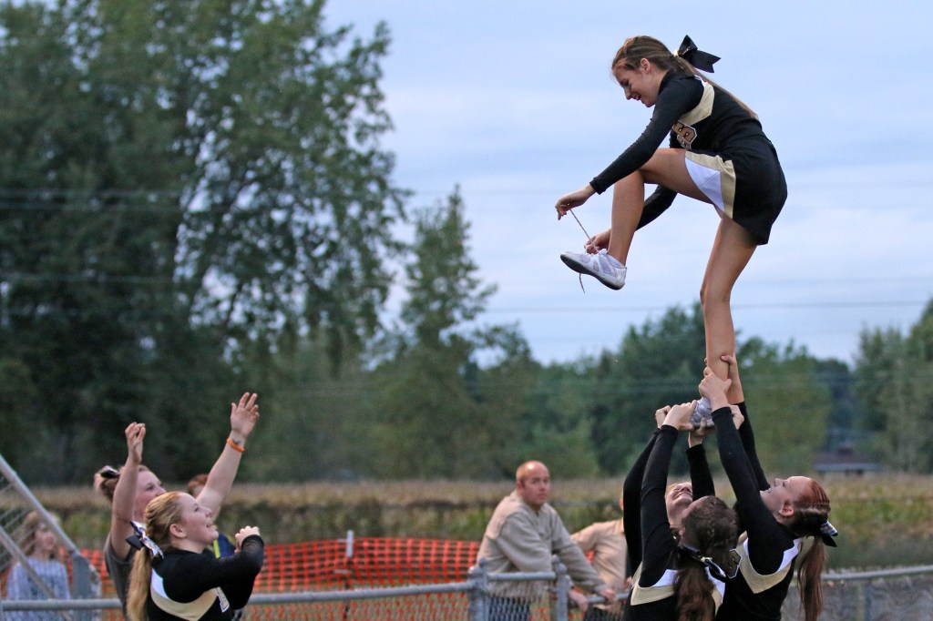 Bullock Creek sophomore Kayla Parsons ties her show while stunted in the air at the Bullock Creek Homecoming game Friday, Sept. 18, 2015. 
