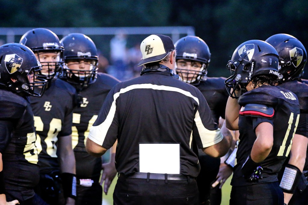 Head coach Steve Miller speaks to his team on Friday, Sept. 18, 2015 at the Bullock Creek Homecoming game. 