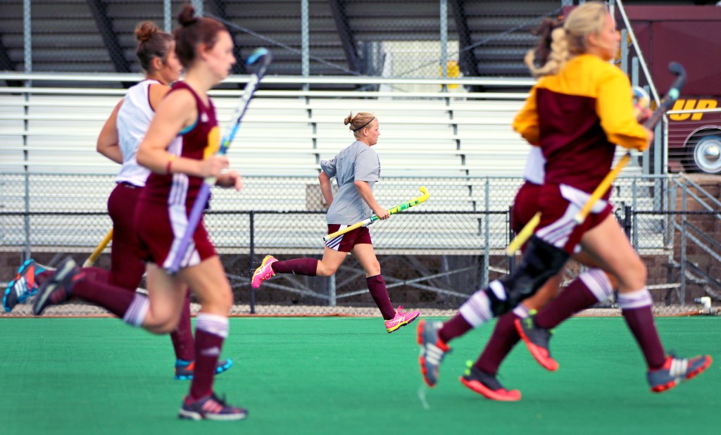 Maude Stalars, center, runs with her teammates during a drill at practice in the Central Michigan Field Hockey Stadium on Friday, Oct. 9, 2015.