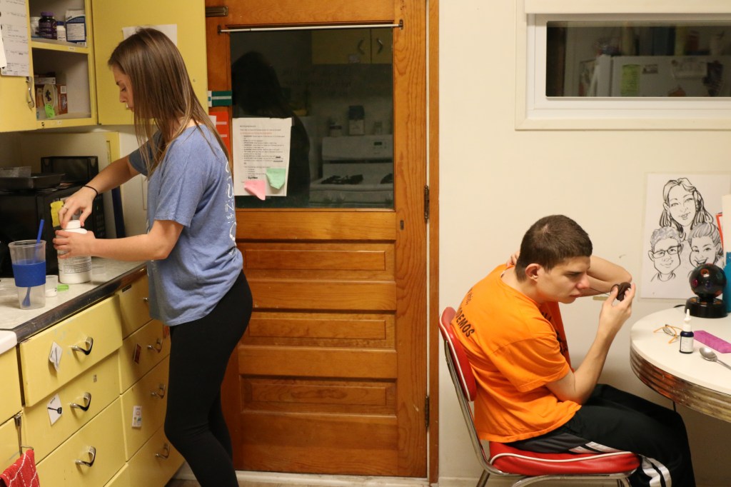 Emily Lane-Waters prepares a meal for Jacob Hartshorne in his kitchen on Nov. 3, 2015.