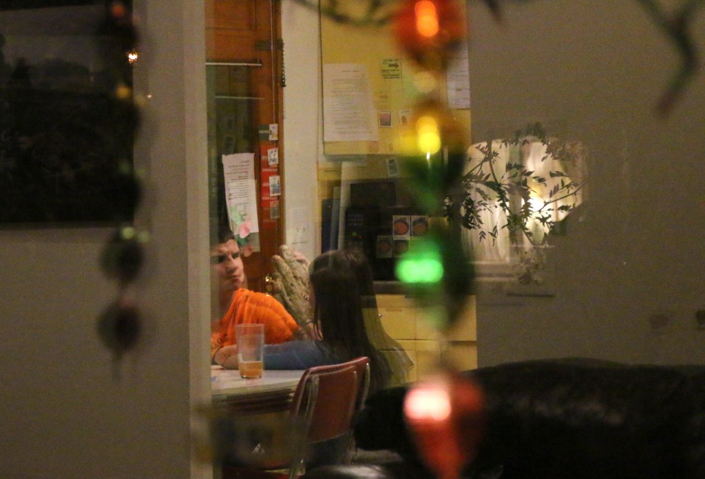 Jacob Hartshorne interacts with one of his caretakers, Emily Lane-Waters on Nov. 3, 2015. Jacob's house is full of bright colors and his caretakers share that he enjoys bright and shiny visual stimulus, like these window decorations.